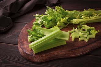 Fresh bunch of celery, top view, no people, on a dark background