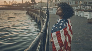 Pensive woman draped in an American flag, standing by the waterfront at dusk, AI generated