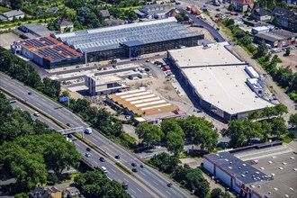 Construction site of a local shopping centre. Rewe Markt, Adler Modemarkt, Risse flower centre in