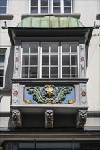 Artfully decorated bay window, stonemasonry work on a historic town house in the monastery quarter,