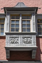 Artfully decorated bay window, stonemasonry work on a historic town house in the monastery quarter,