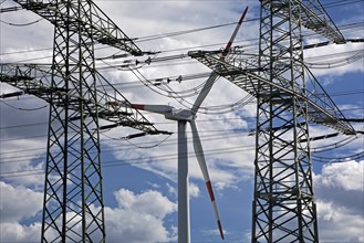 Two overhead line pylons and a wind turbine, Witten, Ruhr area, North Rhine-Westphalia, Germany,