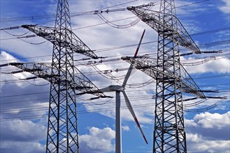 Two overhead line pylons and a wind turbine, Witten, Ruhr area, North Rhine-Westphalia, Germany,