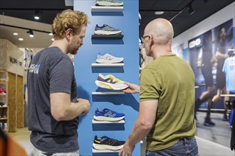 Advice and sale of sporting goods, here running shoes, in retail, Bonn, 31.07.2024. Specialist