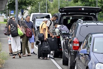 Tourists with wheeled suitcases