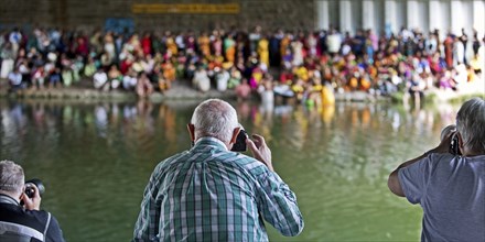 Photographing Hindus under the A2 motorway bridge during ritual purification, Datteln-Hamm Canal,