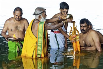 Head priest Siva Sri Arumugam Paskarakurukkal in the Datteln-Hamm canal during ritual purification,