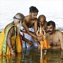 Head priest Siva Sri Arumugam Paskarakurukkal in the Datteln-Hamm canal during ritual purification,