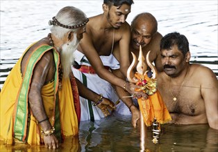 Head priest Siva Sri Arumugam Paskarakurukkal in the Datteln-Hamm canal during ritual purification,