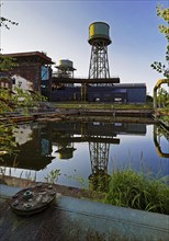 The water tower is reflected in the water basins at the Jahrhunderthalle in Westpark, Industrial