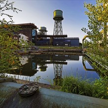 The water tower is reflected in the water basins at the Jahrhunderthalle in Westpark, Industrial