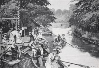 People in boats enjoying a fun time on a river, surrounded by trees, at the New Lake in Berlin