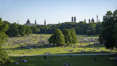 View from the Monopteros in the English Garden, meadows full of visitors on a summer day, Munich