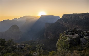 Light mood at sunrise at the Blyde River Canyon, sun rises behind a mountain peak, canyon landscape