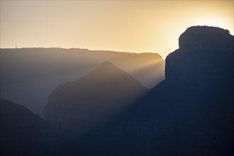 Light mood at sunrise at the Blyde River Canyon, sun rises behind a mountain peak, canyon landscape