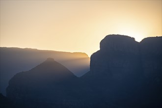 Light mood at sunrise at the Blyde River Canyon, sun rises behind a mountain peak, canyon landscape