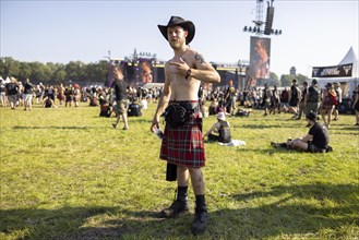 Festivalgoers in kilts at the Wacken Open Air in Wacken. The traditional metal festival takes place