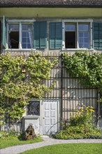 Detail of an old residential building with vines on the façade, Ittingen Charterhouse,