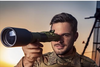 Man in military uniform watching through a telescope at sunset, missile defence, AI generated, AI