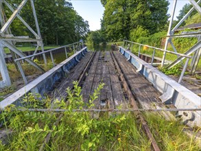 Landing stage of the historic railway ferry with overgrown old rails on the banks of the Havel in