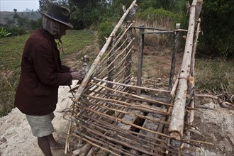 Man building toilets (Near Ambositra, Madagascar), He belongs to the Betsileo ethnic group