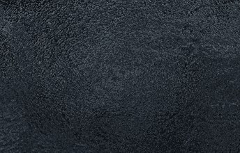 A textured black abstract surface with a rough appearance