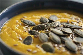 Close up of seasonal pumpkin soup with seeds. Generative Ai, AI generated