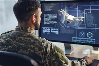 A soldier monitors and controls a drone via a digital user interface on a large screen, AI