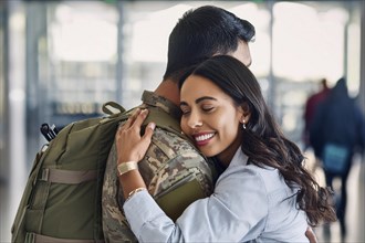 A woman hugs a soldier in an airport and shows a happy smile, AI generated, AI generated