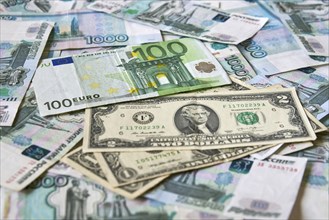 Background of paper bills dollars, euros and rubles. Currency exchange rate