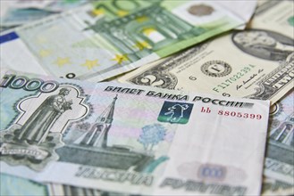 Background of paper bills dollars, euros and rubles. Currency exchange rate