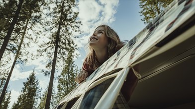 A smiling girl leaning out of a camper, looking up at the sky surrounded by tall trees, AI