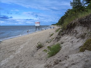 DLRG stand on the beach, sandy beach, clouds in the blue sky on the island of Usedom on the Baltic