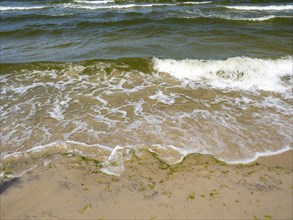 Water flowing onto the sandy beach on the island of Usedom on the Baltic Sea, Zempin,