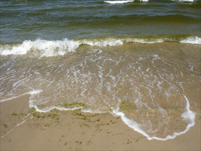 Water flowing onto the sandy beach on the island of Usedom on the Baltic Sea, Zempin,