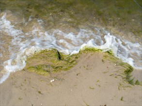 Water flowing onto the sandy beach on the island of Usedom on the Baltic Sea, Zempin,