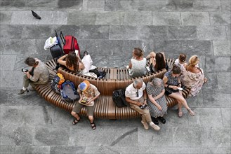 Young and old bench with mobile phone