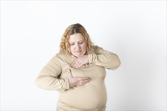 Plus size woman doing a Breast Self-Exam (BSE)