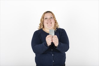 Woman smiling happily showing her credit card