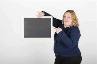 Woman holding a black poster without text. Business template concept. White background