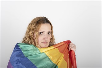 Studio shot of woman holding LGBT rainbow flag