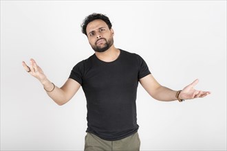 Latin young man arguing. White background