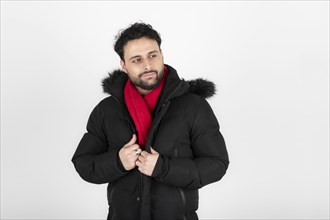 Portrait of latin man wearing black coat and red scarf