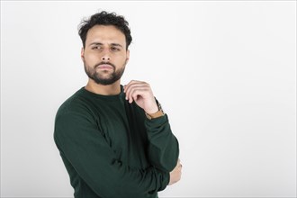 Portrait of a latin man looking to the side. White background