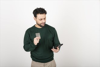 Young man making an online purchase with a credit card