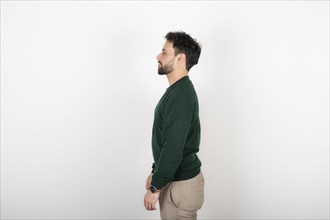 Portrait of a young latin man in profile on white background