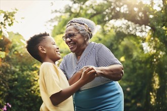 Older woman hugging a boy in the garden, both smiling and enjoying the moment together, ai