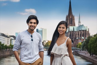 Two people smiling in front of a cathedral in a city near a river on a sunny day, ai generated, KI