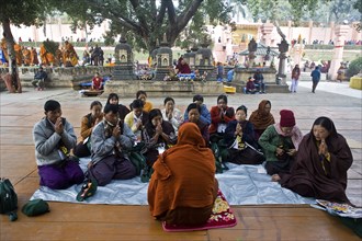 Buddhist monk teaching some buddhist principles to buddhist pilgrims from Myanmar (Mahabodhi temple