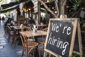 Chalkboard with English text saying 'We're hiring' at restaurant. Concept for labour shortag.